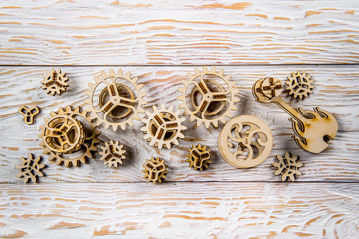 wooden gears lie on the white table desk