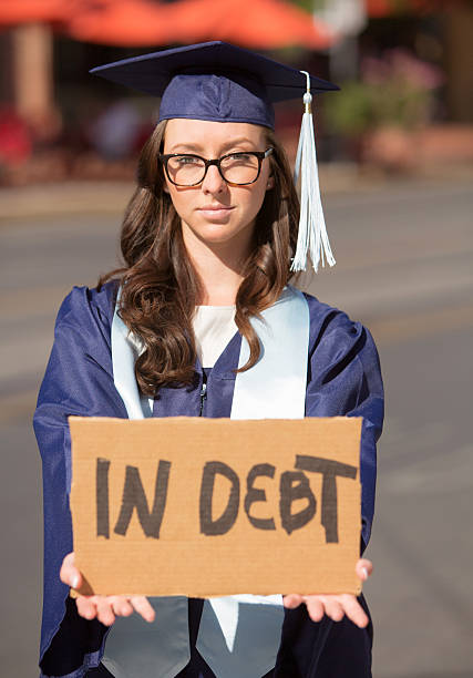 istock Woman Holding In Debt Sign 525974046