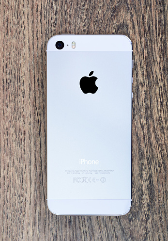 Minsk, Belarus - April 16, 2016: Apple iPhone 5, 5S. White version. Back view. The operating system iOS 9. The founders of the company: Steve Jobs, Ronald Wayne, Steve Wozniak. Apple Inc. Located in USA.