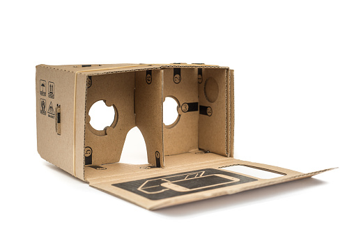London, England - April 29, 2016: Google Cardboard is an open source  virtual reality headset made from cardboard that uses a modern smartphone. The plans can be downloaded from the internet and edited for your needs, The kit also includes a magnet that works as a switch, two lenses and an RFID tag.