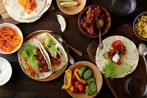 istock Mexican Tacos with ground beef and pork, carrots, cucumber, corn 525977278