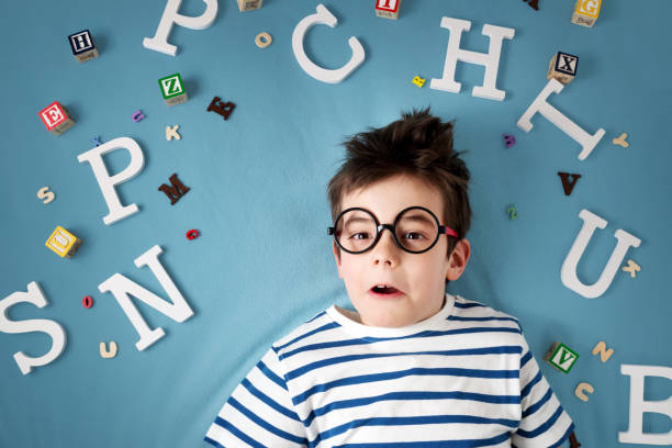 istock seven years old child lying with glasses and letters 525978024
