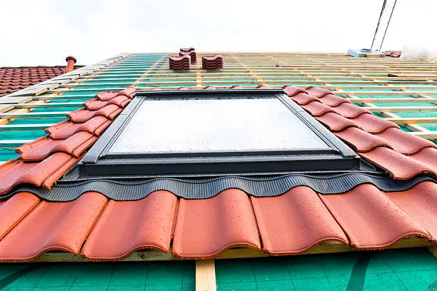 New built house, roof with a new installed skylight.