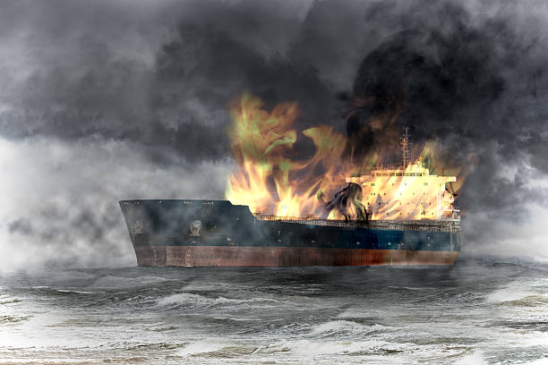 Burning ship on sea stock photo