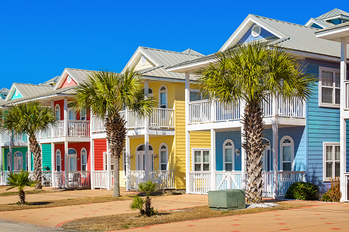 Photo of colorful homes along the beach in Panama City Beach, Florida, USA on a clear blue sky day.