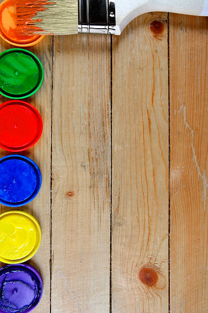 istock Paintbrush with paints on a wooden background 525982000
