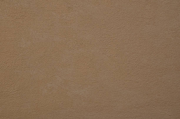 istock grainy yellow background of cement 525984890