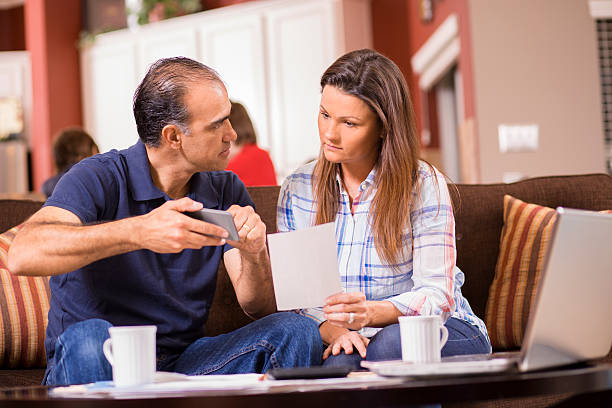 istock Latin descent couple paying monthly bills at home. 525985698