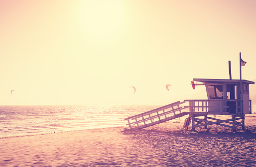Vintage toned picture of lifeguard tower at sunset, Malibu, USA.