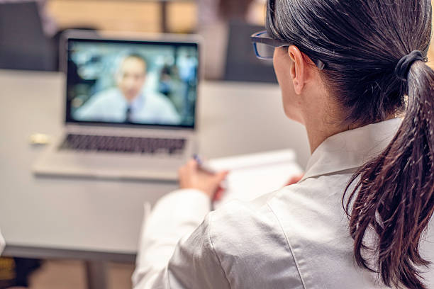 istock Rear view of a doctor having a video conference 525986358