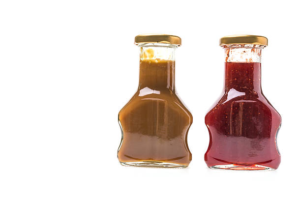 istock Caramel sauce and strawberry jam bottles 525986767