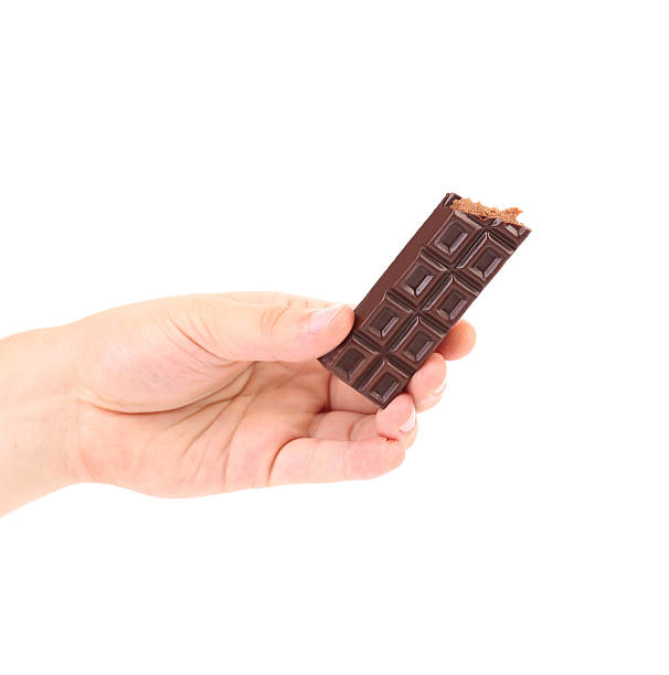istock Hand holding chocolate bar with filling. 525988843
