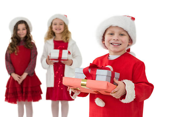 istock Festive little siblings smiling at camera holding gifts 525991325