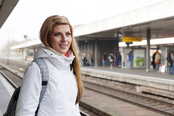 istock young woman waiting for the train 525991439