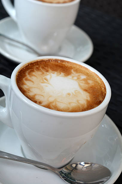 istock Cup Of Foamy Cappuccino On The Black Background 525991861