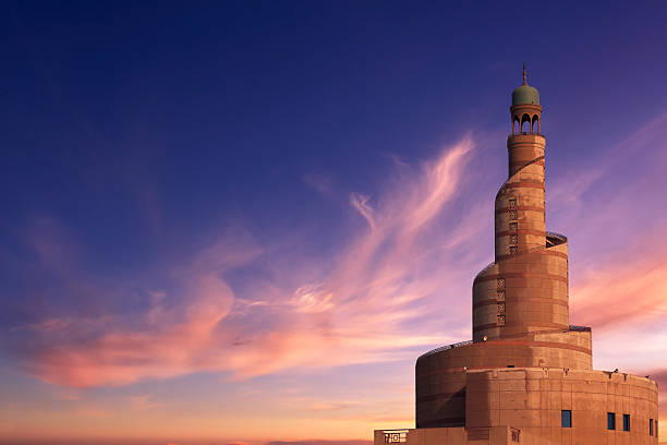 The minaret of the Islamic Cultural Center and Mosque in Doha, Qatar, in the evening.