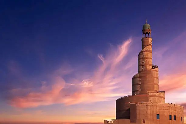 The minaret of the Islamic Cultural Center and Mosque in Doha, Qatar, in the evening.
