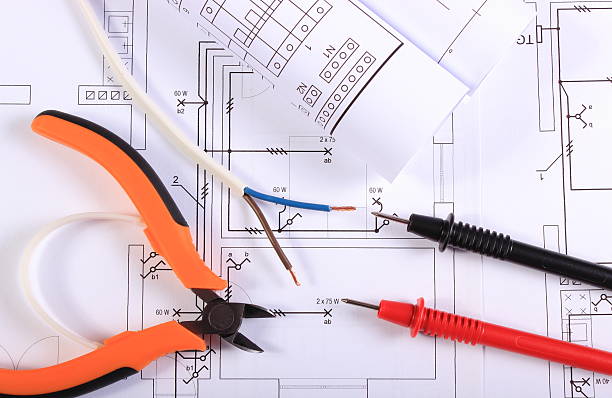 istock Cables of multimeter, pliers, electric wire and construction drawing 525991985