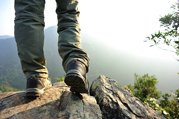 istock hiking feet  mountain peak rock 525992295