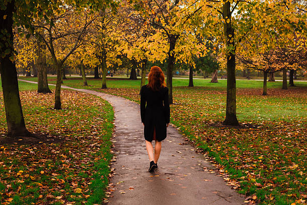 istock Young woman walking in park 526017199
