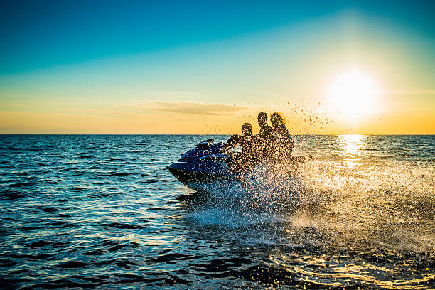 istock Family Riding  Jet Boat at Sunset 526019407