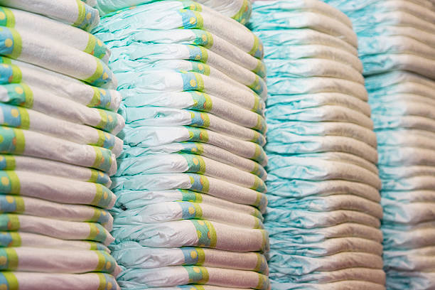 Children's diapers stacked in a piles stock photo