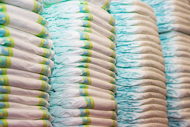 Children's diapers stacked in a piles Children's diapers stacked in a piles in the child room. Diaper stock pictures, royalty-free photos & images