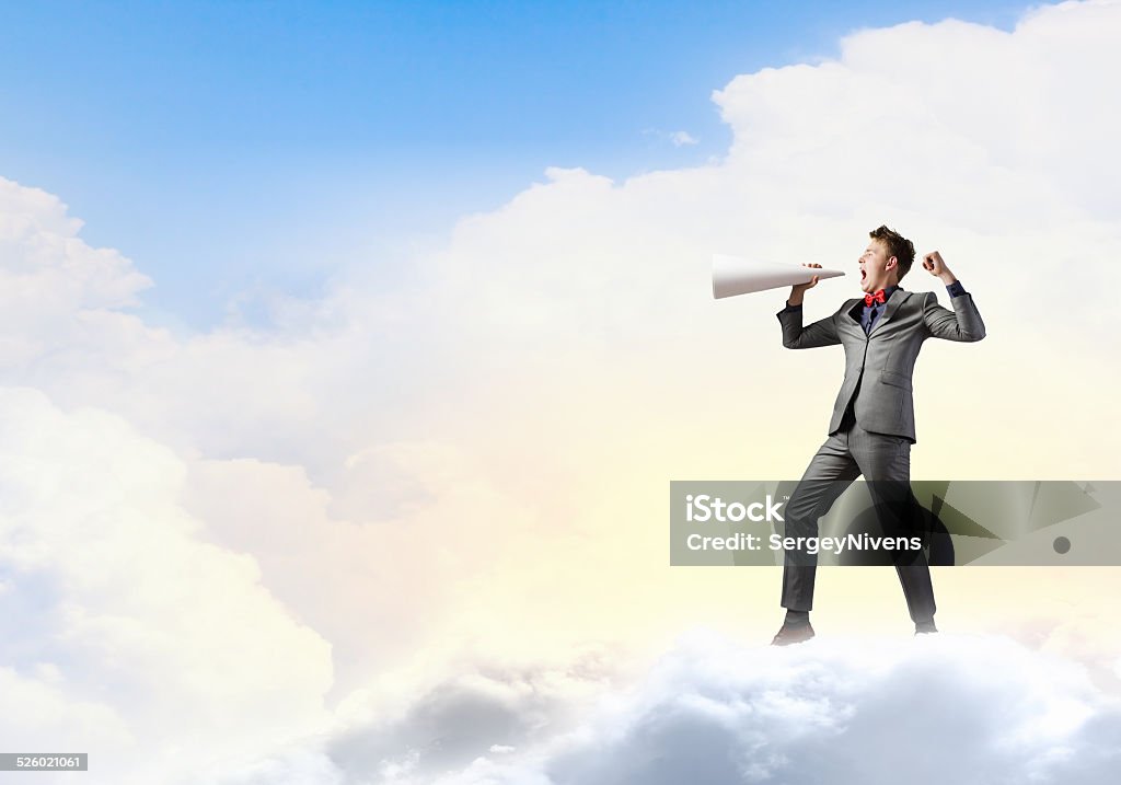 Man with trumpet Young excited businessman screaming in paper trumpet Adult Stock Photo