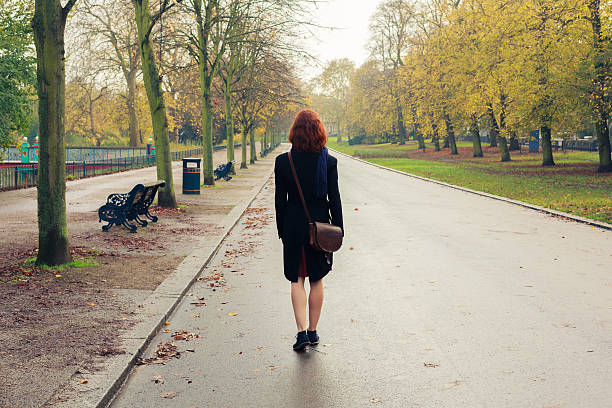 istock Young woman walking down avenue 526021503