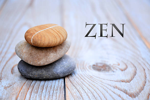 istock Three Zen stones on a wooden background 526024497