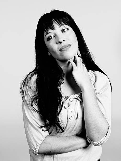 istock Cute brunette daydreams, hand on chin 526035513
