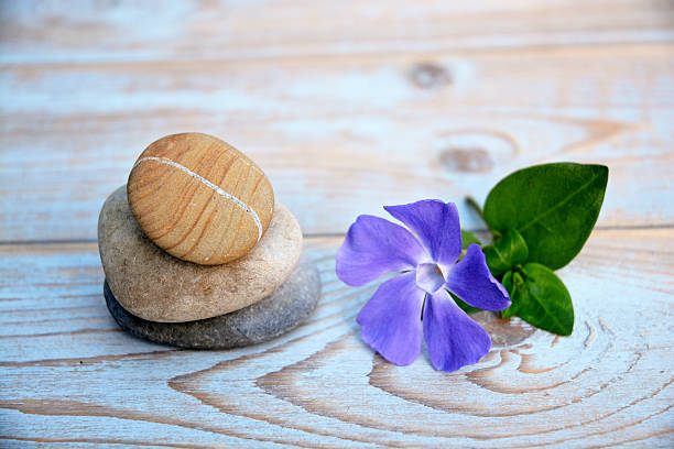 istock Three Zen stones on a wooden background 526036125