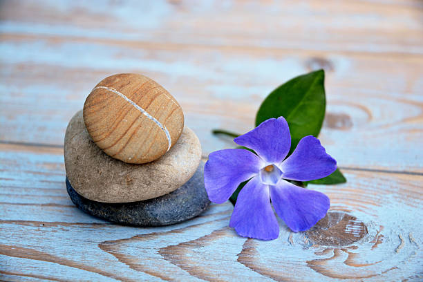 Three Zen stones on a wooden background