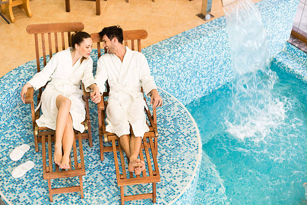 Young couple relaxing by the swimming pool.