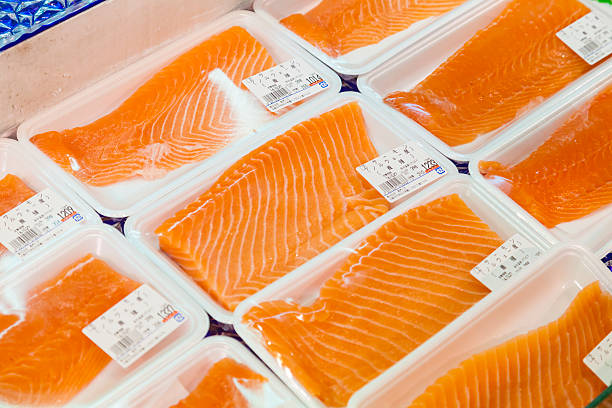 Osaka, Japan - October 26, 2014: Sashimi for sale in a seafood store in the Kuromon Market in Osaka, Japan. Sashimi is a Japanese food, which is raw meat or fish sliced into thin pieces.