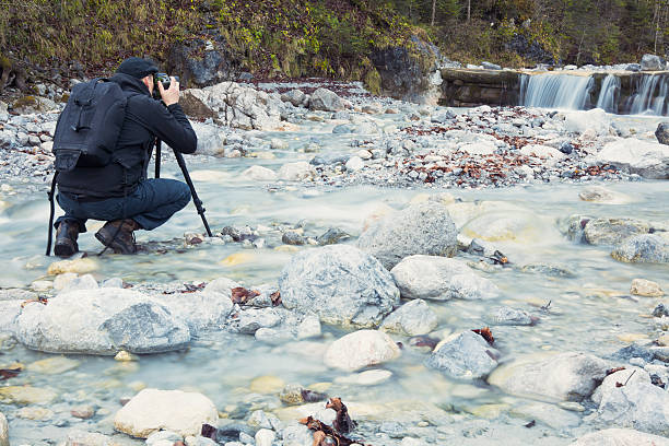 istock Photographer take a picture of a waterfall 526037877