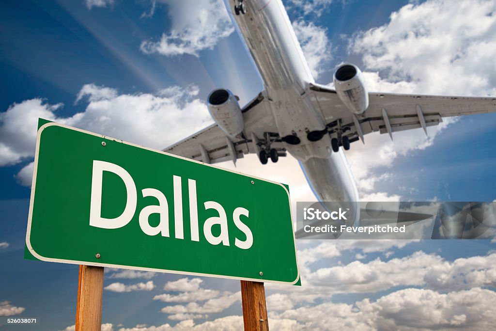 Dallas Green Road Sign and Airplane Above Dallas Green Road Sign and Airplane Above with Dramatic Blue Sky and Clouds. Relocation Stock Photo