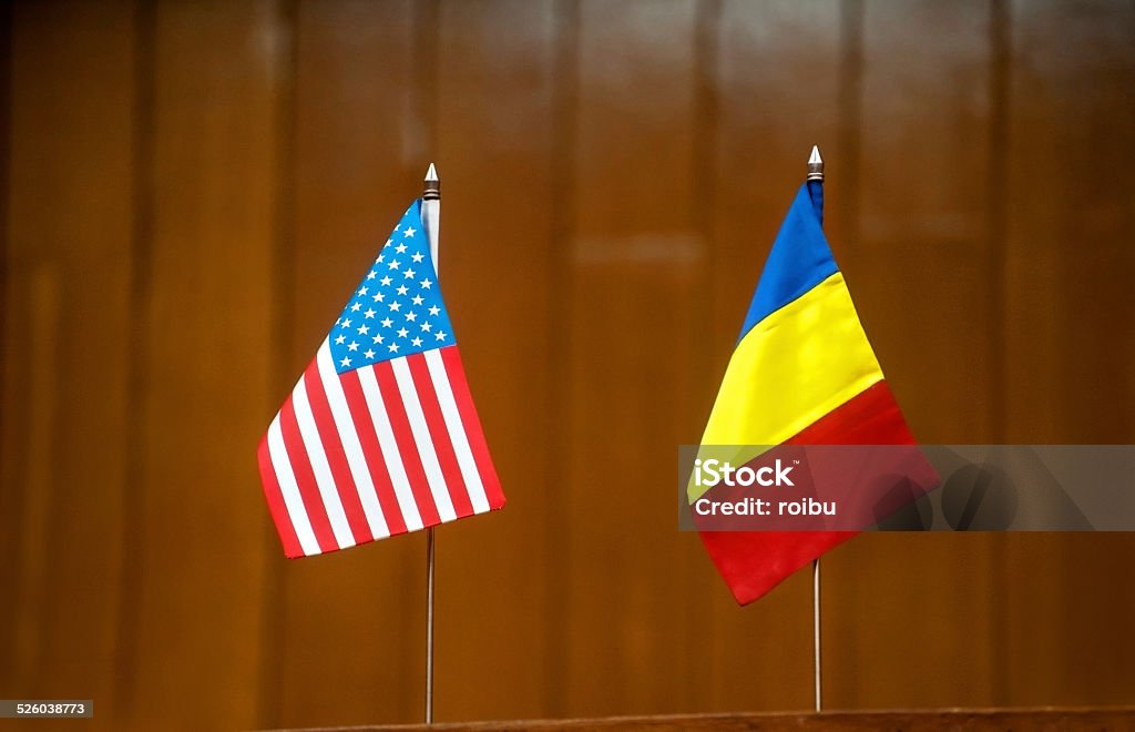 American and romanian table flags American and romanian table flags at a press conference Agreement Stock Photo