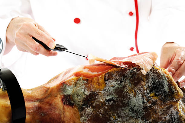 Cook cutting serrano ham