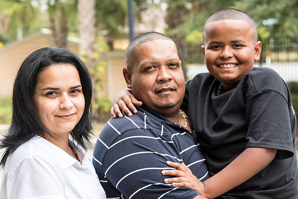 Photo of a real Hispanic family. Hispanic man posing smiling with his wife and son fat mexican man pictures stock pictures, royalty-free photos & images