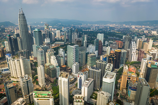 Aerial view over the skyscrapers and landmarks of Kuala Lumpur, Malaysia's vibrant capital city, from the iconic spires of the twin Petronas Towers to the hotels and malls of Bukit Bintang. ProPhoto RGB profile for maximum color fidelity and gamut.