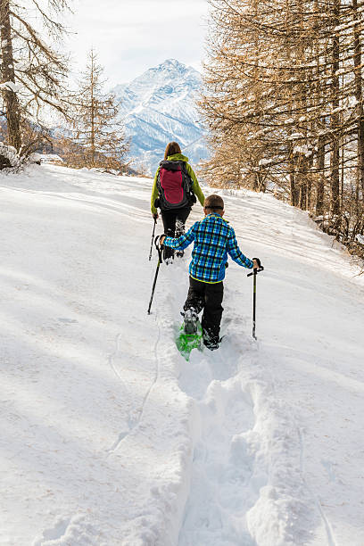 istock Mother and Son Snowshoeing 526054853