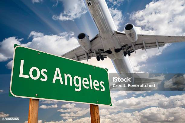 Los Angeles Green Road Sign And Airplane Above Stock Photo - Download Image Now - Airplane, Airport, Blue