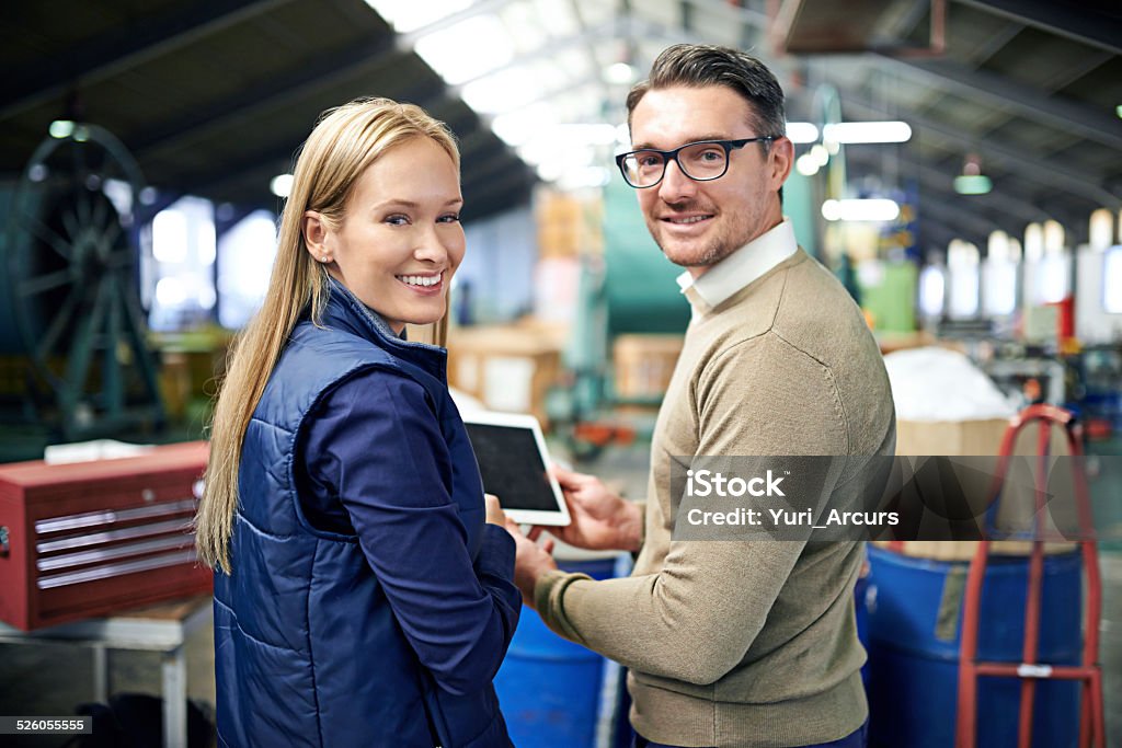 Our warehouse is fully equipped Cropped shot of a two coworkers managing a warehouse Adult Stock Photo