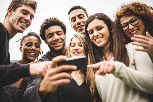 istock friends watching the selfies done on the phone 526056013