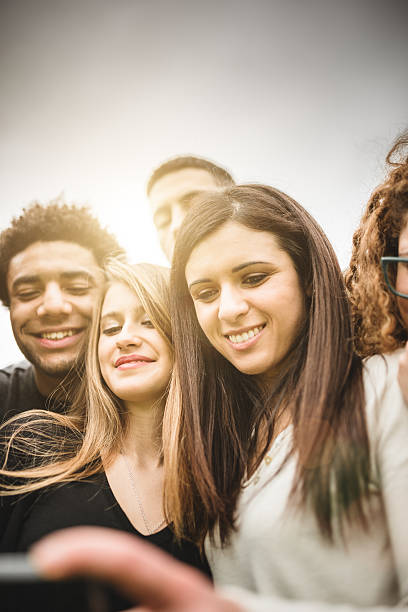 istock friends watching the selfies done on the phone 526056021