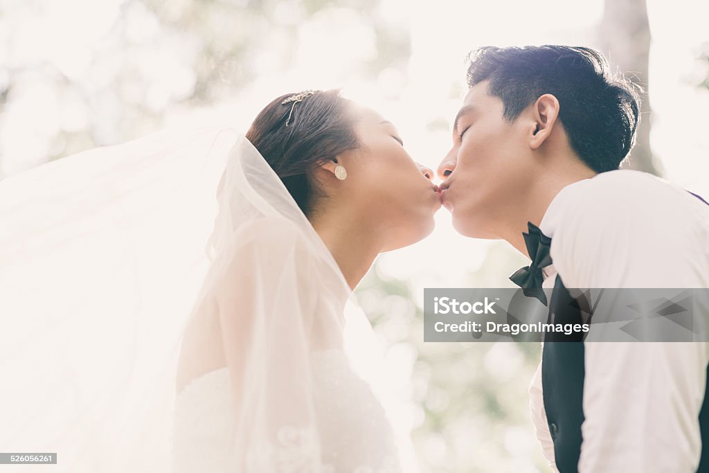 First kiss Just married couple kissing for the first time Wedding Stock Photo