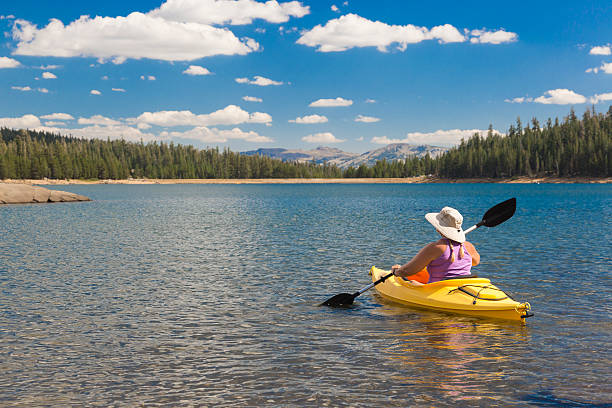 istock Woman Kayaking on Beautiful Mountain Lake. 526057977