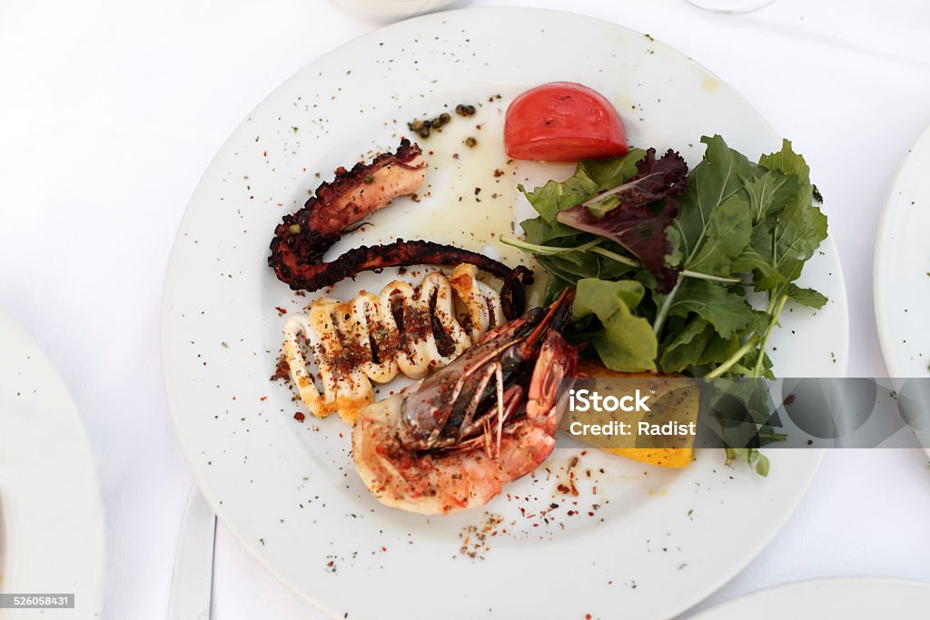Grilled seafood with vegetables Grilled seafood with vegetables on a white plate Appetizer Stock Photo