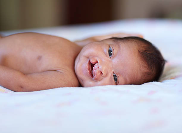 She's such an angel Portrait of a baby girl with a cleft palate lying on a bed half dressed girls pictures stock pictures, royalty-free photos & images